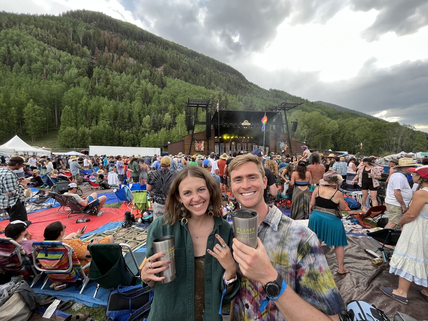 Jack and Danika toasting in a crowd at an outdoor show